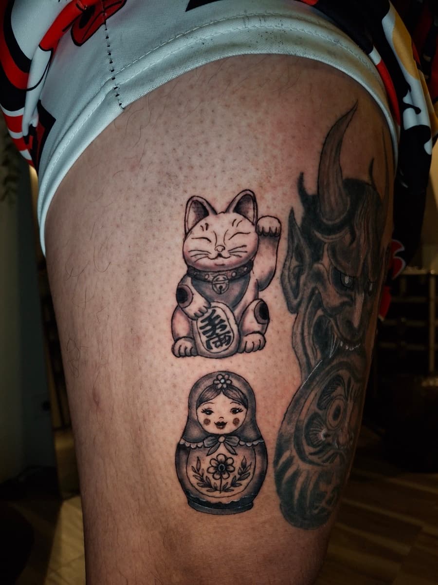japanese maneki-neko lucky cat and matryoshka doll leg tattoo by isaiah recongco — gorillaz tattoo art studio philippines